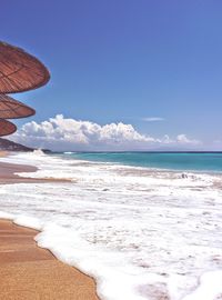 View of beach against blue sky