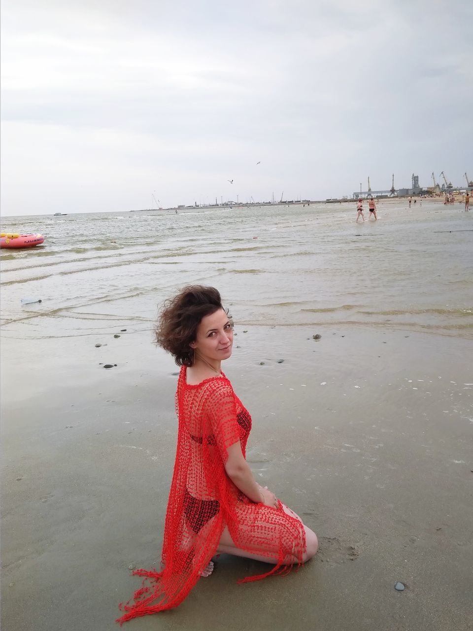 water, sky, beach, one person, real people, sea, land, lifestyles, leisure activity, young women, young adult, casual clothing, beauty in nature, nature, red, scenics - nature, day, beautiful woman, outdoors, hairstyle