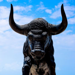 Low angle view of horse statue against sky