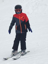 Low section of man standing on snow