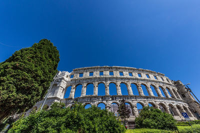 Low angle view of historical building against blue sky