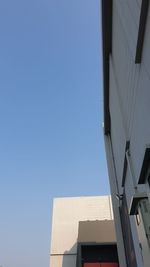 Low angle view of modern building against clear blue sky