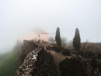 Scenic view of mountains against sky during foggy weather