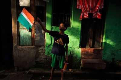 Full length of man standing against wall