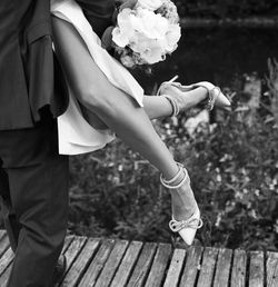 Midsection of couple holding hands