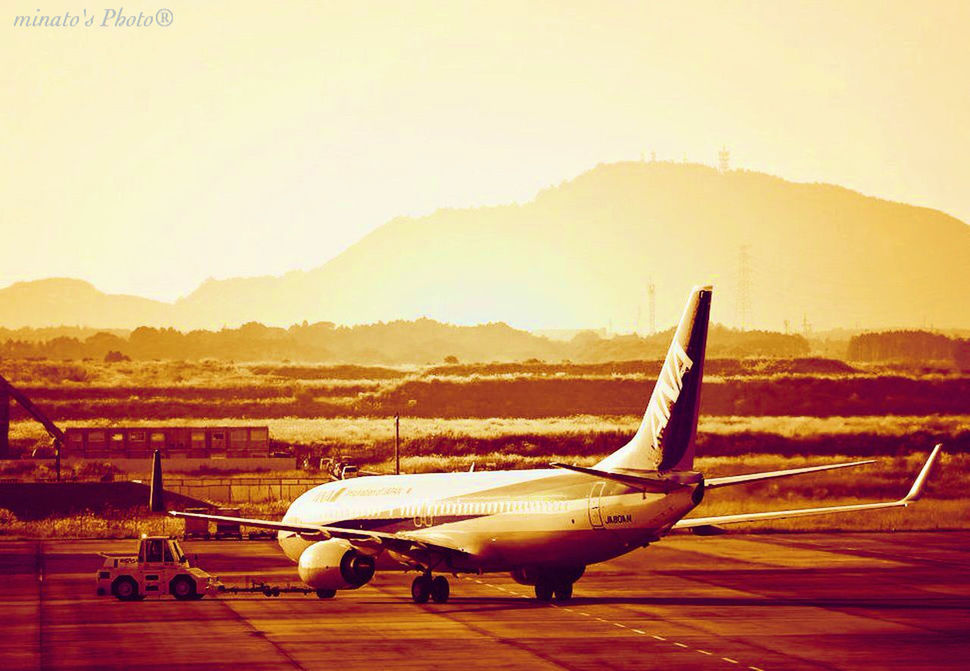 transportation, landscape, clear sky, sunset, mode of transport, mountain, copy space, field, travel, sky, desert, outdoors, mid-air, nature, scenics, car, orange color, flying, rural scene, tranquil scene