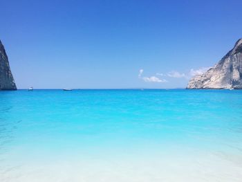 Scenic view of sea against clear blue sky