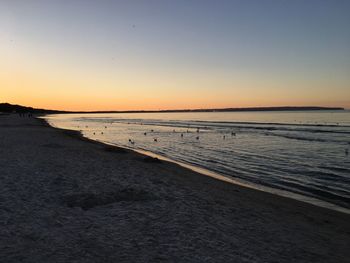 Scenic view of beach against sky during sunset