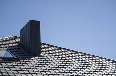 Low angle view of modern building against clear blue sky