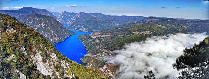 High angle view of lake and mountains against sky