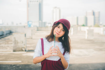 Beautiful young woman standing in city