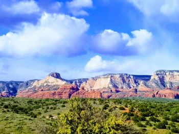 Scenic view of mountain range against cloudy sky