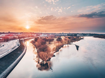 Aerial view of river against sky during sunset