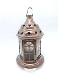 Close-up of lantern against white background