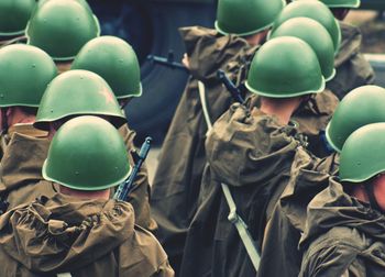 Close-up high angle view of army men in helmets