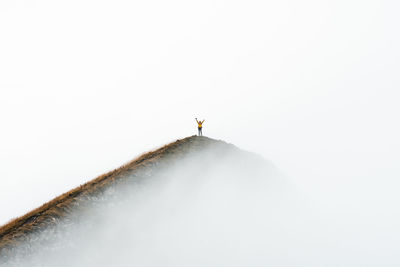 Distant view of man standing on hill