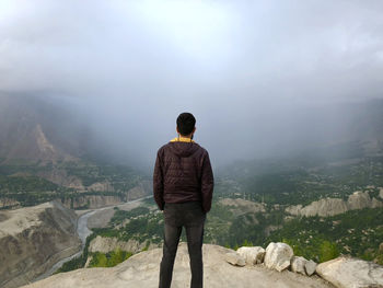 Rear view of man standing on mountain