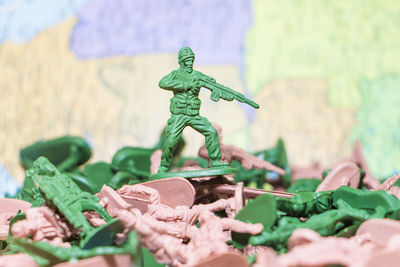 Close-up of army soldier figurine aiming rifle