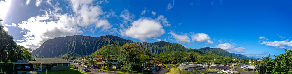 Panoramic view of trees and houses against sky