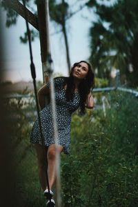 Young woman smiling while standing on land