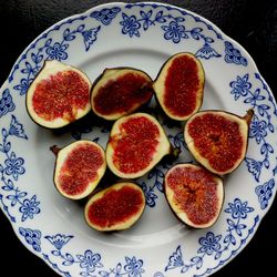 Directly above shot of halved figs in plate on table