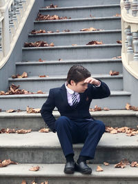 Full length of boy sitting on staircase