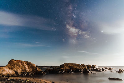 Scenic view of rocks against sky at night