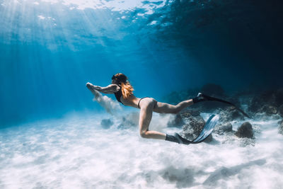 Young woman swimming in sea