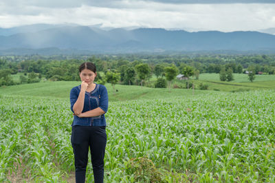 Portrait of woman standing in field