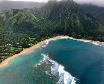 Scenic view of sea and mountains against sky