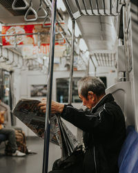 Man using mobile phone in train