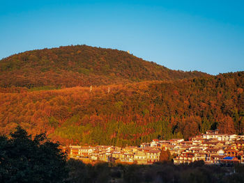 Scenic view of mountains against clear blue sky