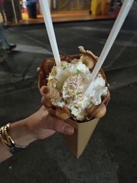 Close-up of hand holding ice cream cone