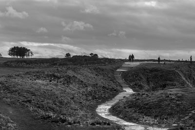 Scenic view of landscape against cloudy sky