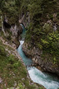 High angle view of stream amidst rocks in forest