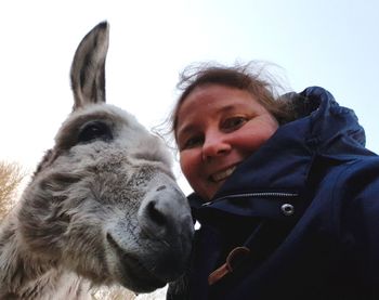 Portrait of woman with donkey