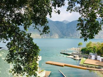 High angle view of swimming pool by lake against sky