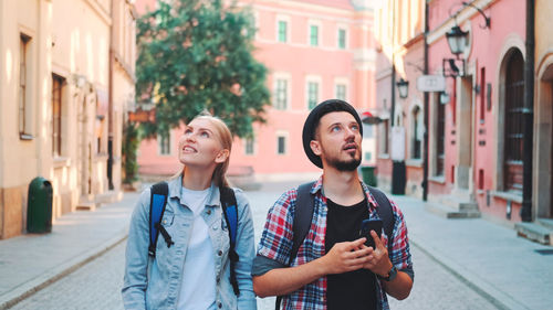 Portrait of young woman standing in city