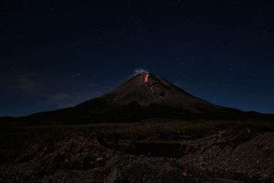 Scenic view of landscape against sky at night