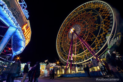 Illuminated ferris wheel at night