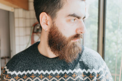 Portrait of young man looking away at home