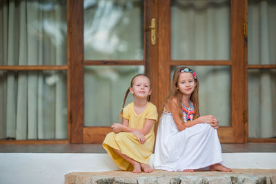 Portrait of smiling girl sitting outdoors