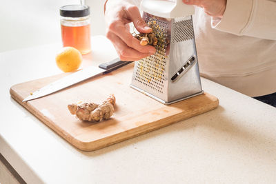 High angle view of person having food on cutting board