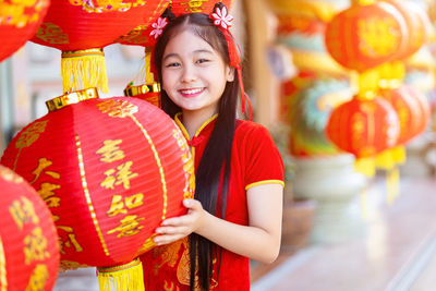 Portrait of happy woman with red lantern