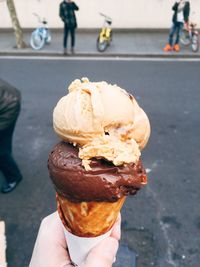 Close-up of hand holding ice cream cone