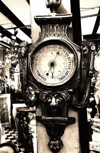 Low angle view of clock against sky