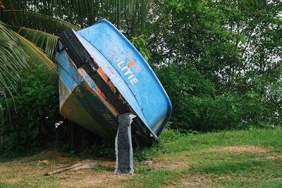 Abandoned boat on grass