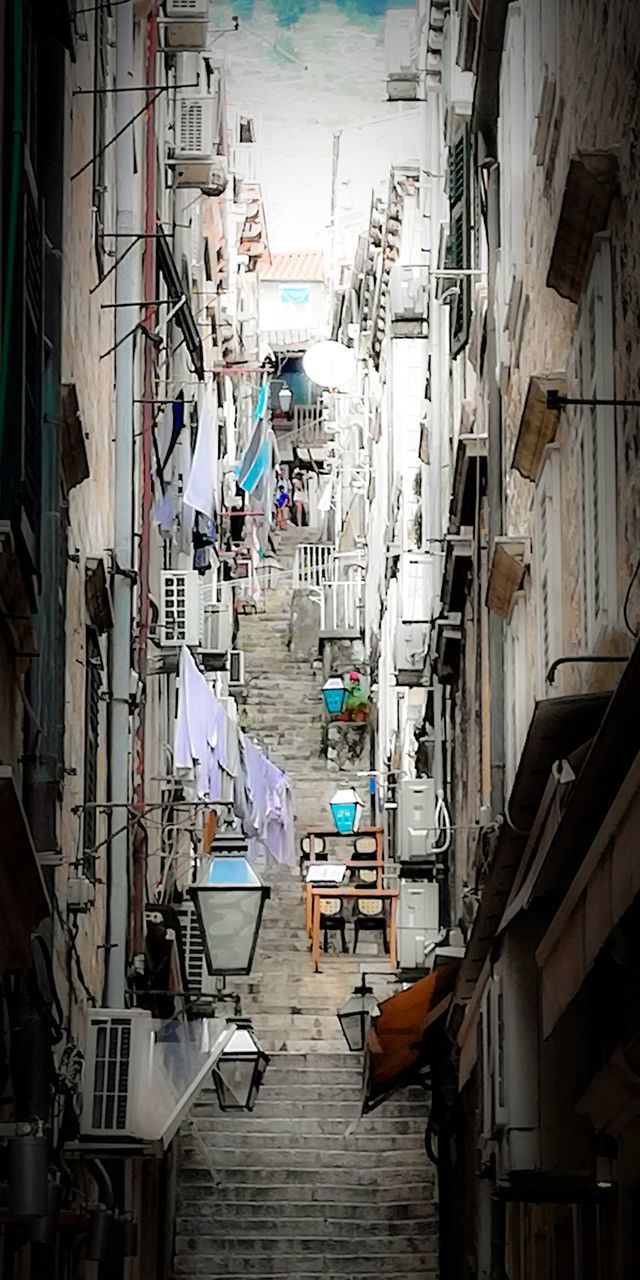 HIGH ANGLE VIEW OF NARROW ALLEY AMIDST BUILDINGS