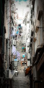 High angle view of people on alley amidst buildings in city