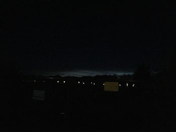 Illuminated building against sky at night